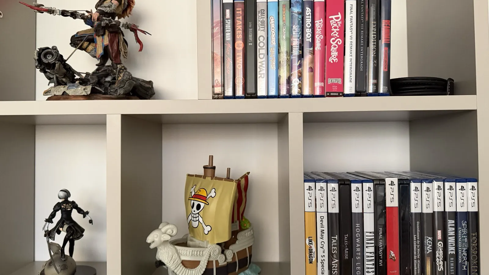 Shelf with physical PlayStation games and video game figures